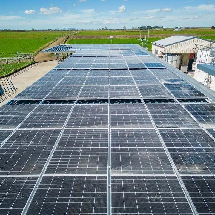 Large-scale rooftop solar installation on rural farm shed in New Zealand