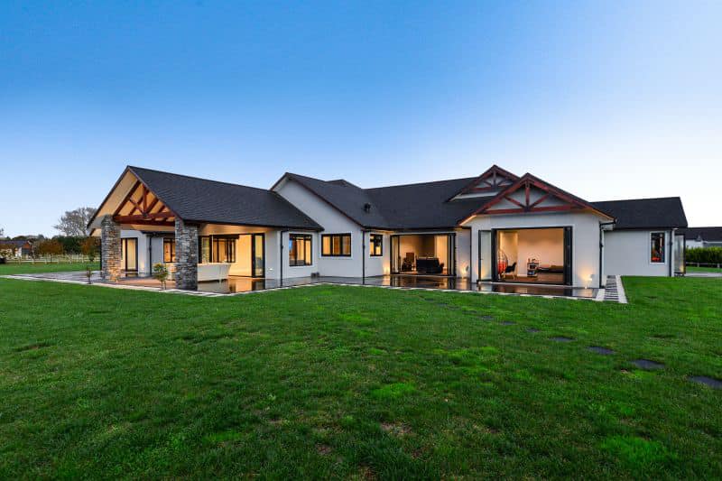 Modern rural home with architectural lighting and landscape design in Waikato
